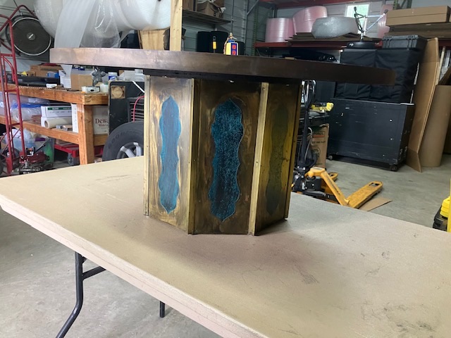 Table base or pedestal staged on a work surface before wrapping