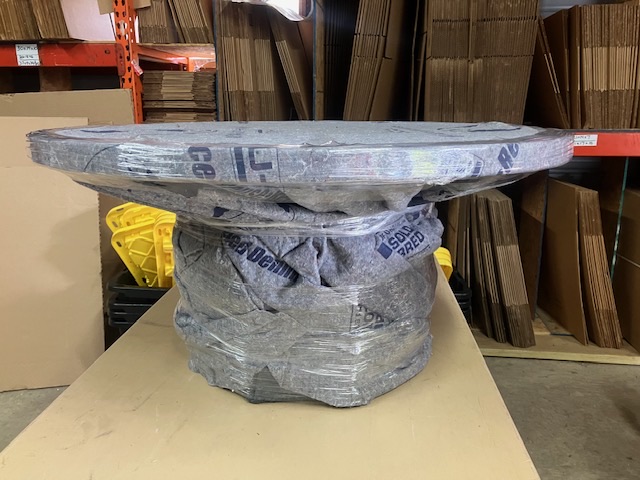 Round table wrapped with protective material