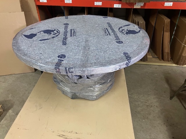 Wrapped round table staged on a work surface