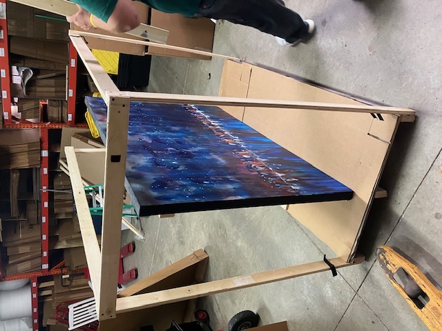 Painted framed piece staged on a wood support frame