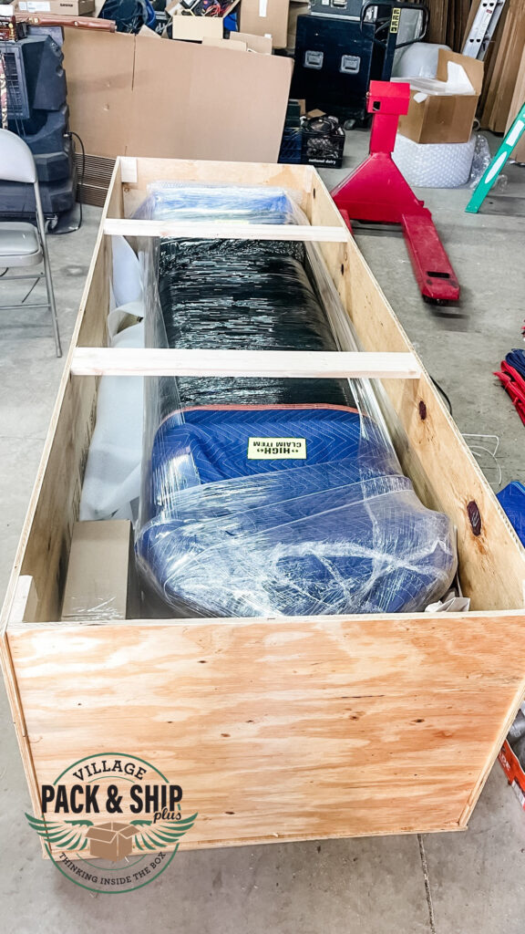 Large item set inside a wood-sided packing frame